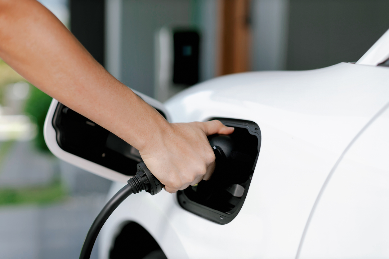 Progressive idea of charging electric vehicle via cable from charging station. EV Home Charger Installation Near Me